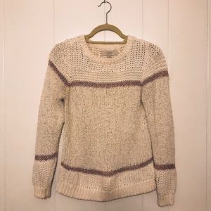 White sweater with pink details.